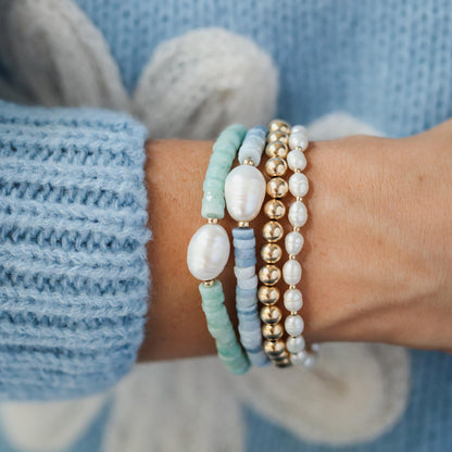 Heishi gemstone and pearl bracelet by Earthly Abundance featuring smooth stones and white pearls on a delicate cord.