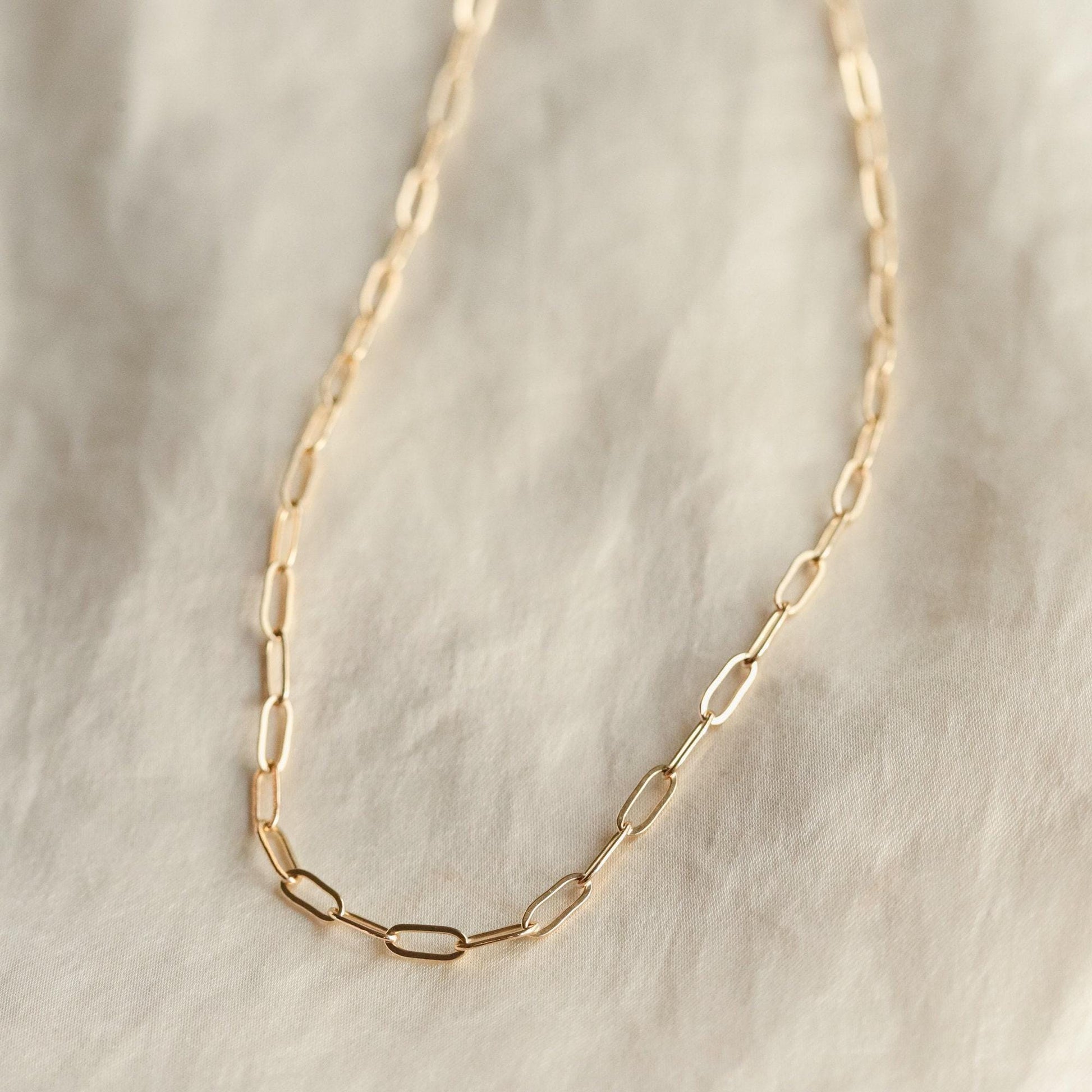 14K gold-filled Everyday Gold Necklace by Earthly Abundance, close-up of delicate chain and clasp on a neutral background.