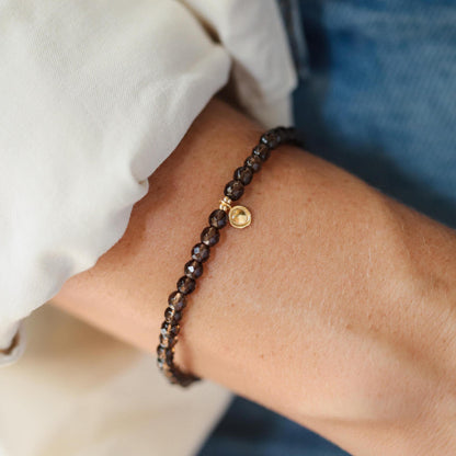 Smoky Quartz bracelet by Earthly Abundance featuring polished beads with natural smoky gray color and elastic stretch band.