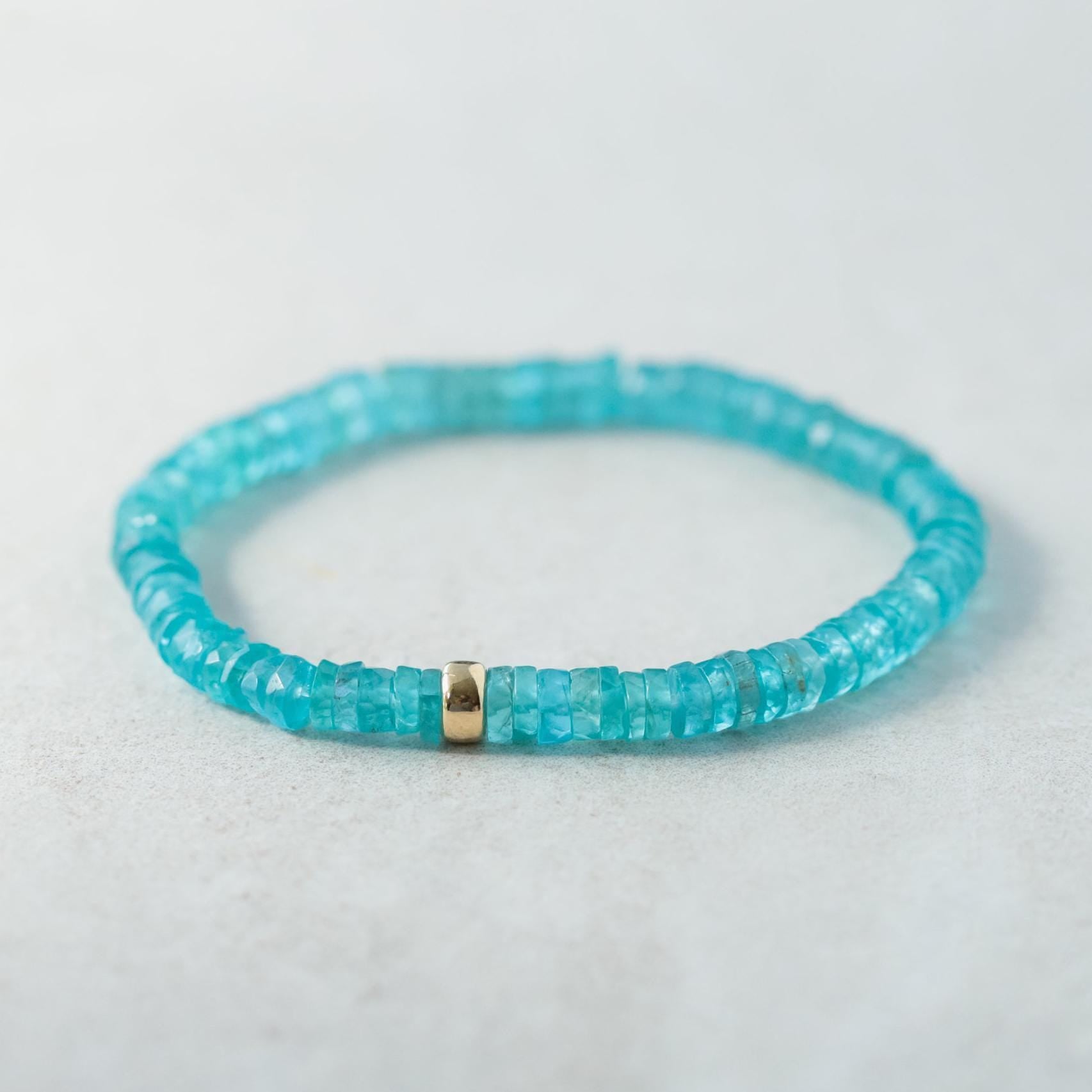 Earthly Abundance Apatite Heishi bracelet with small blue-green gemstone beads and elastic stretch band.