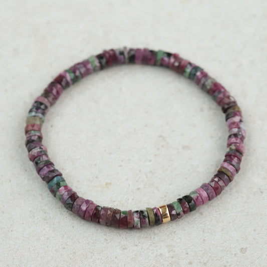 Ruby Zoisite Heishi bracelet featuring small, round gemstone beads in vibrant green and pink tones, strung on elastic cord.
