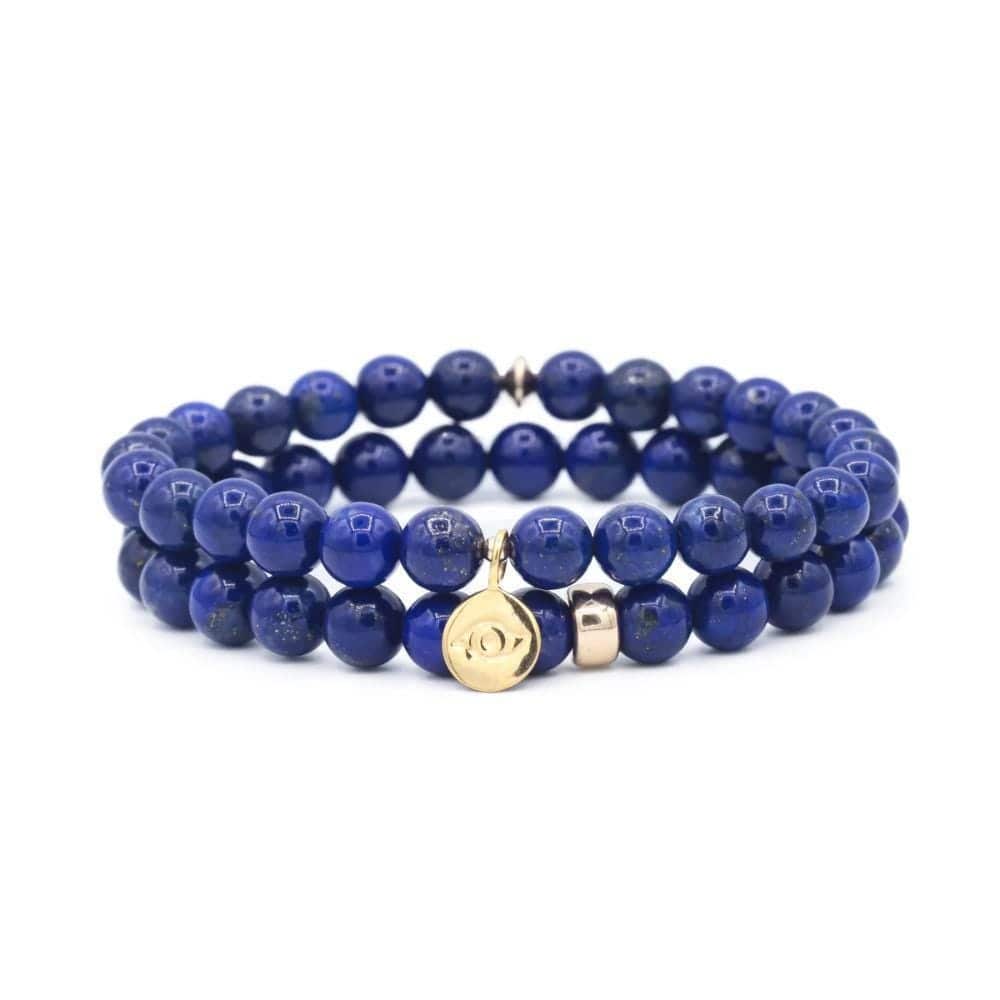 Lapis Lazuli bracelet from Earthly Abundance Jewelry featuring deep blue stones with gold accents on a delicate elastic band.