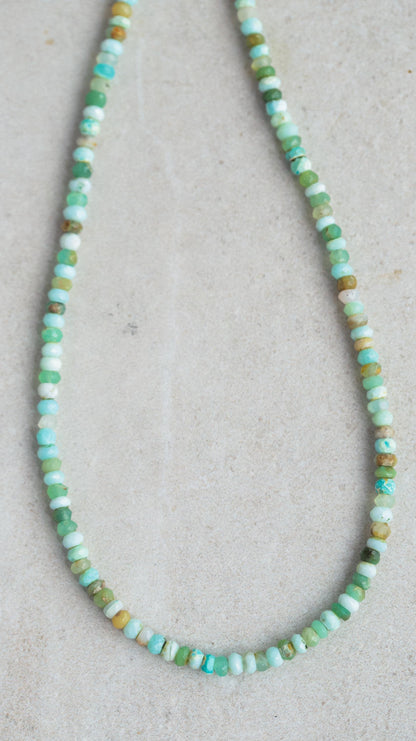 Peruvian opal necklace featuring vibrant, polished stones on a delicate chain, styled for elegant wear.