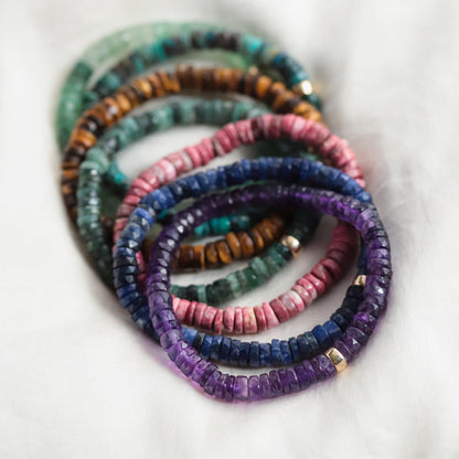 Radiant Ombré Amethyst Heishi bracelet featuring small, colorful gemstone beads on a stretch elastic band, by Earthly Abundance.