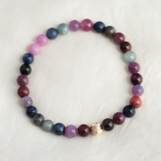 Elegant Ruby and Sapphire bracelet featuring 14K gold from Earthly Abundance, showcasing vibrant gemstones and fine craftsmanship.