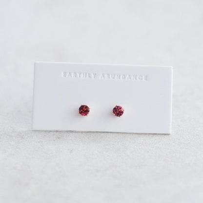 Pink tourmaline stud earring by Earthly Abundance featuring a sparkling pink gemstone set in a silver or gold stud.