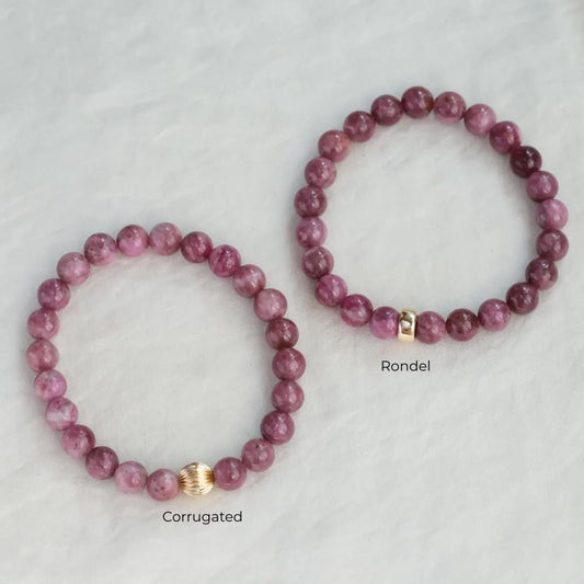 Pink tourmaline bracelet with 14K gold setting from Earthly Abundance, showcasing vibrant pink gemstones on a delicate chain.