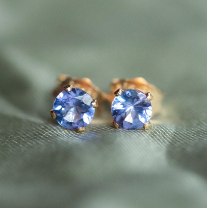 Earthly Abundance tanzanite stud earrings featuring vibrant blue-purple gemstones set in silver.
