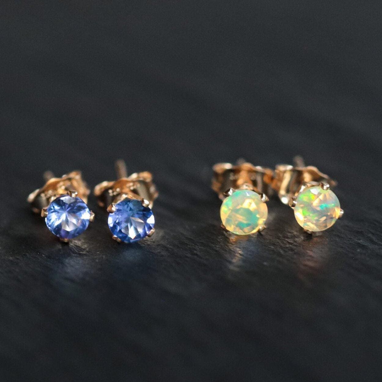 Earthly Abundance tanzanite stud earrings featuring vibrant blue-purple gemstones set in silver.