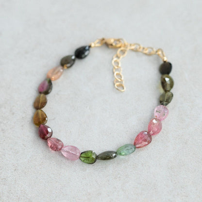 Faceted pear-shaped tourmaline bracelet with 14K gold-filled setting, showcasing vibrant gemstones and elegant craftsmanship.