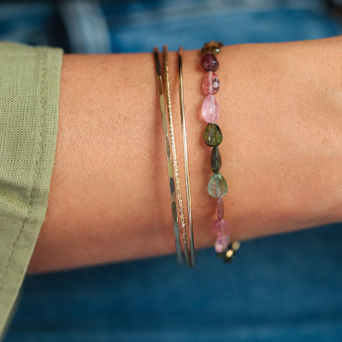 Faceted pear-shaped tourmaline bracelet with 14K gold-filled setting, featuring vibrant gemstones on a delicate chain.