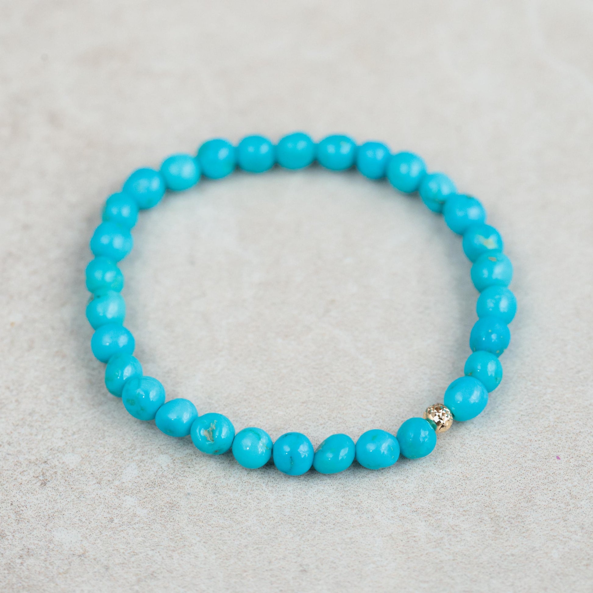 Earthly Abundance Jewelry Sleeping Beauty everyday bracelet featuring turquoise-colored beads and a delicate charm design.