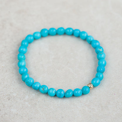 Earthly Abundance Jewelry Sleeping Beauty everyday bracelet featuring turquoise-colored beads and a delicate charm design.
