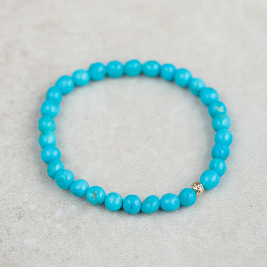 Earthly Abundance Jewelry Sleeping Beauty everyday bracelet featuring turquoise-colored beads and a delicate charm design.