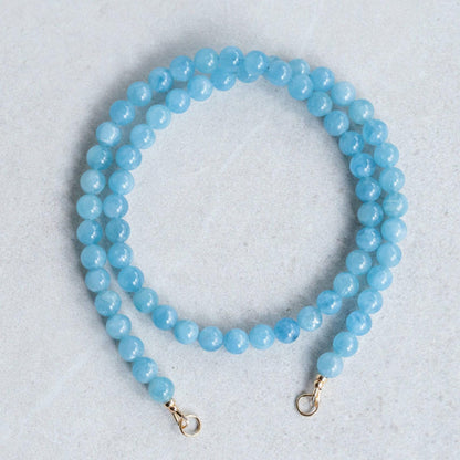 Aquamarine carabiner necklace by Earthly Abundance featuring a silver-toned metal clasp and a polished aquamarine gemstone.