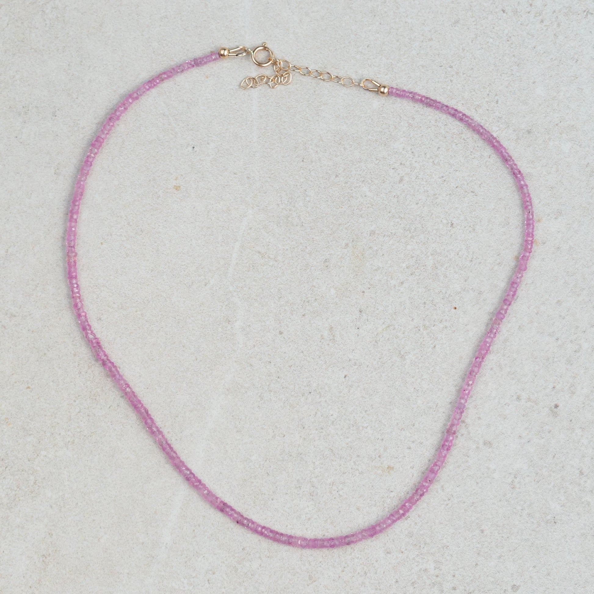 Pink sapphire necklace featuring a delicate chain and vibrant pink sapphires from Earthly Abundance.