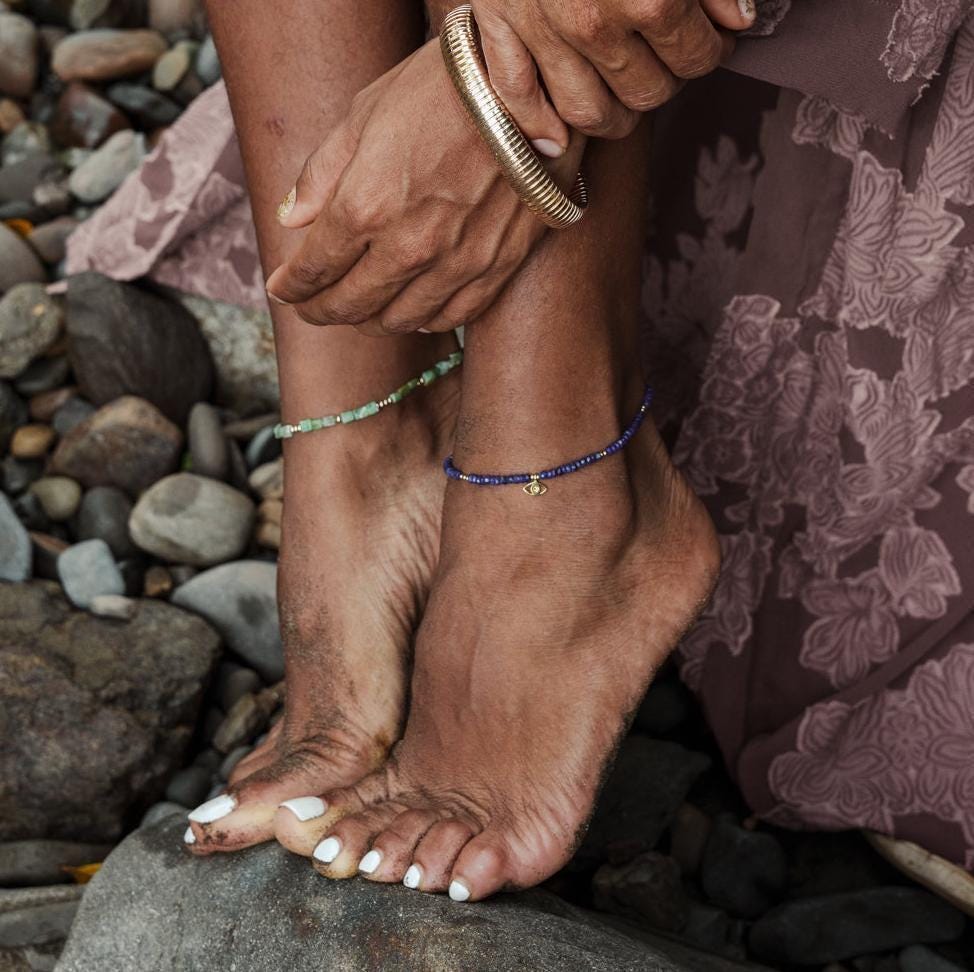 Square cut Peruvian Opal anklet in 14K gold filled with Earthly Abundance branding, showcasing the jewelry on a delicate ankle.