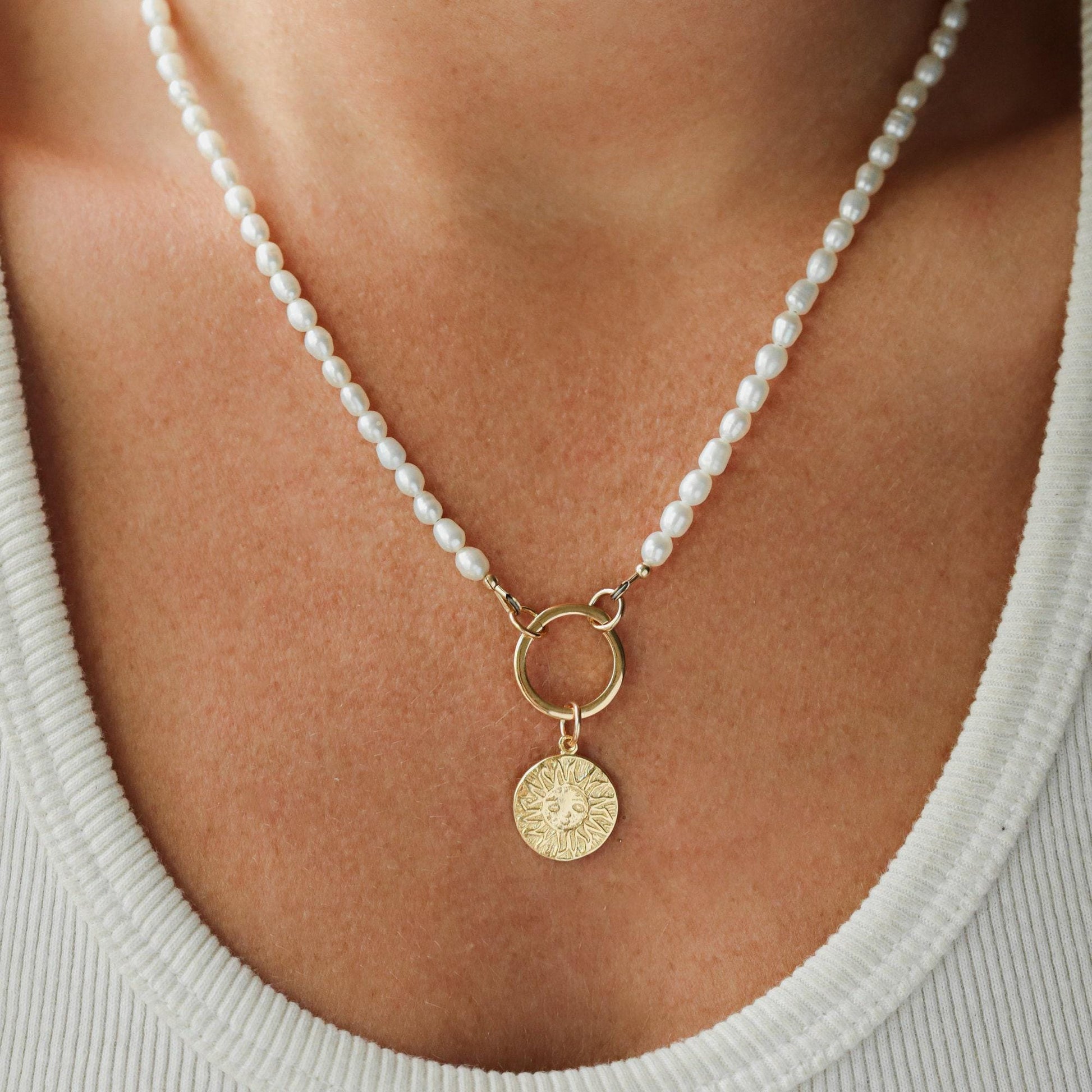Earthly Abundance Solstice Pearl Necklace featuring lustrous white pearls on a delicate chain, elegant jewelry accessory.