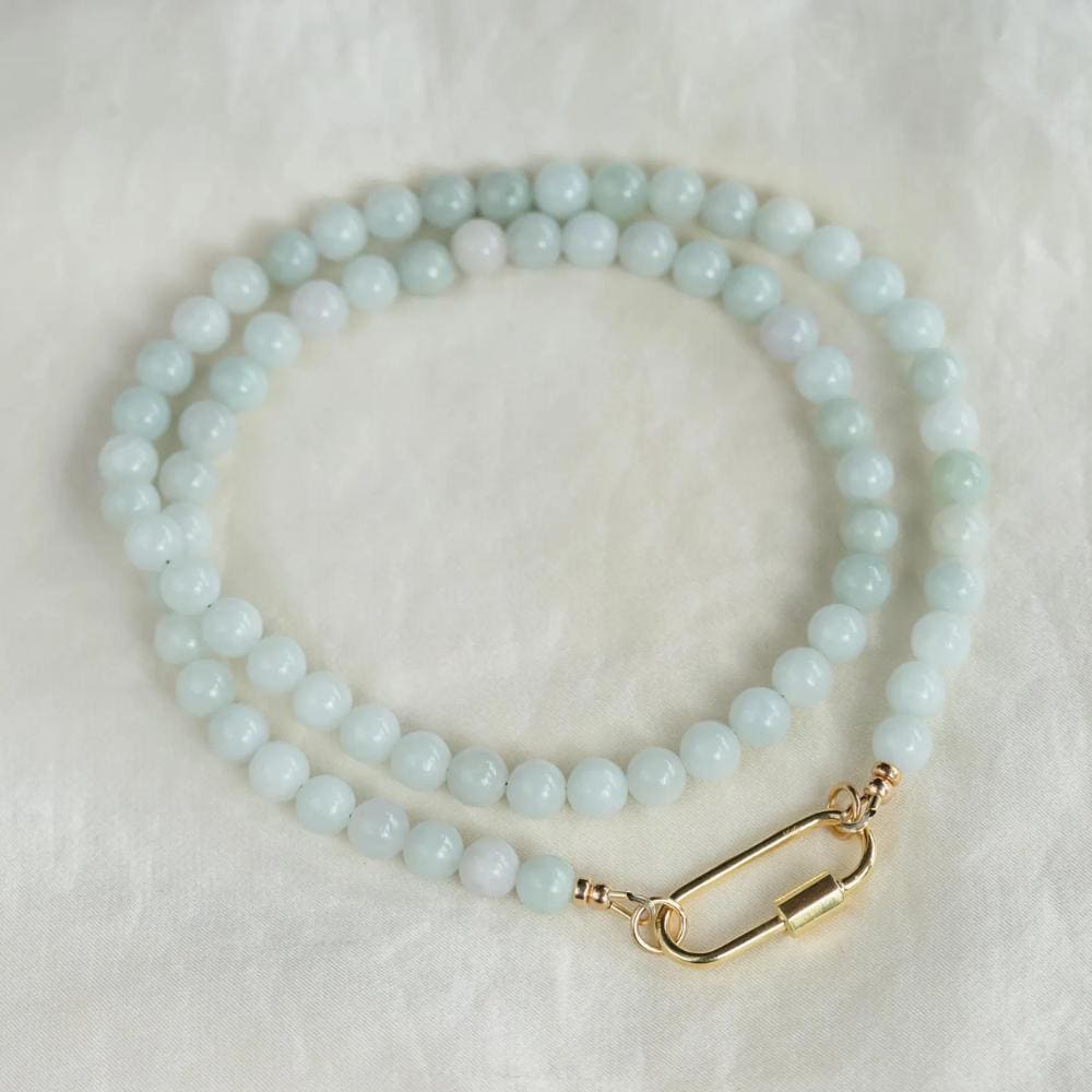 Elegant jadeite necklace featuring smooth, polished jade stones with a natural green hue, symbolizing harmony and protection.