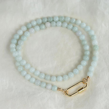 Elegant jadeite necklace featuring smooth, polished jade stones with a natural green hue, symbolizing harmony and protection.