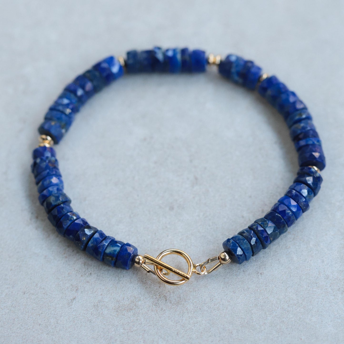 Lapis Lazuli toggle bracelet from Earthly Abundance featuring deep blue stones with gold flecks and a toggle clasp design.