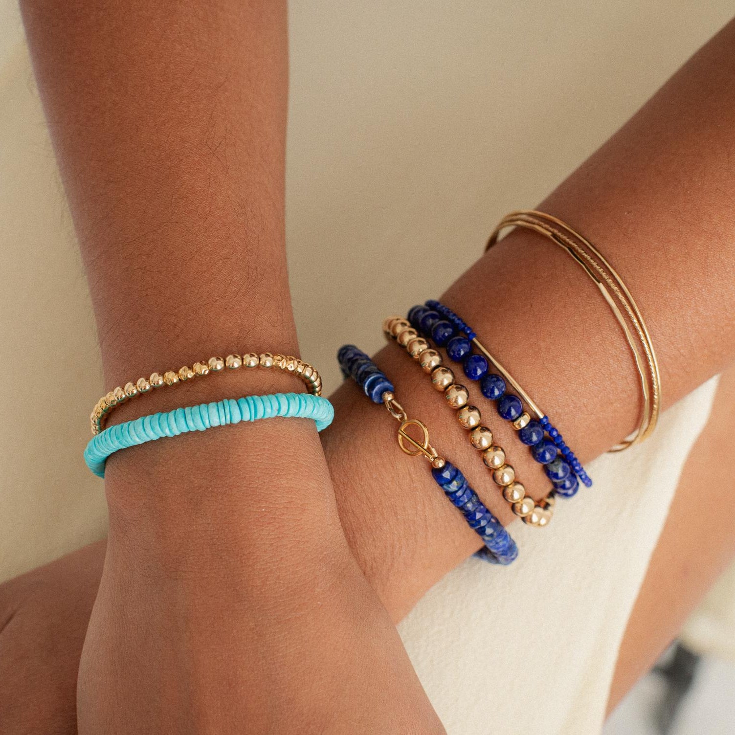 Lapis Lazuli toggle bracelet by Earthly Abundance featuring deep blue stones with gold accents on a white background.