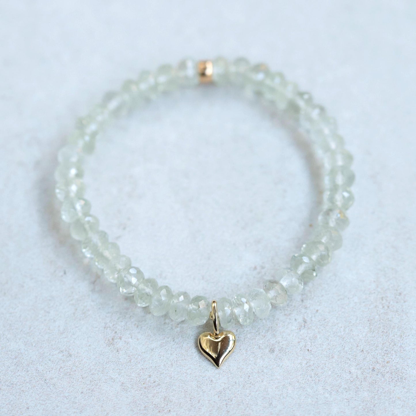 Earthly Abundance Aurelia Heart Bracelet featuring green amethyst gemstones on a delicate chain, showcasing elegant jewelry design.