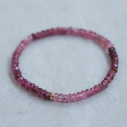 Open heart pink tourmaline bracelet with 14K gold setting from Earthly Abundance, featuring pink gemstone beads and heart-shaped charm.