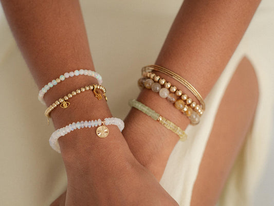 Gold beaded charm bracelet with 4mm beads from Earthly Abundance featuring intricate beaded details and a charm.