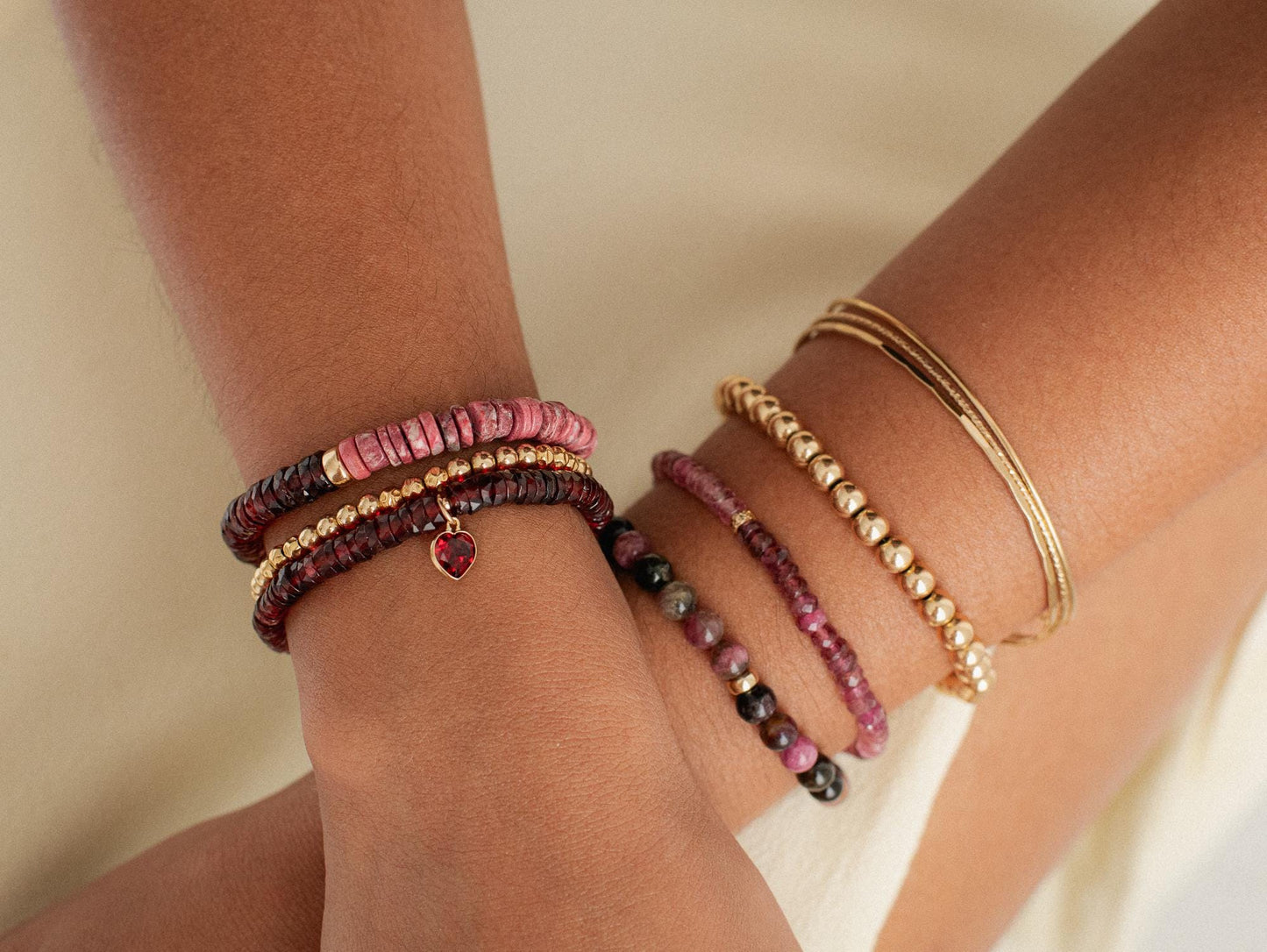 Open heart pink tourmaline bracelet featuring 14K gold accents, showcasing delicate pink gemstones on a fine gold chain.