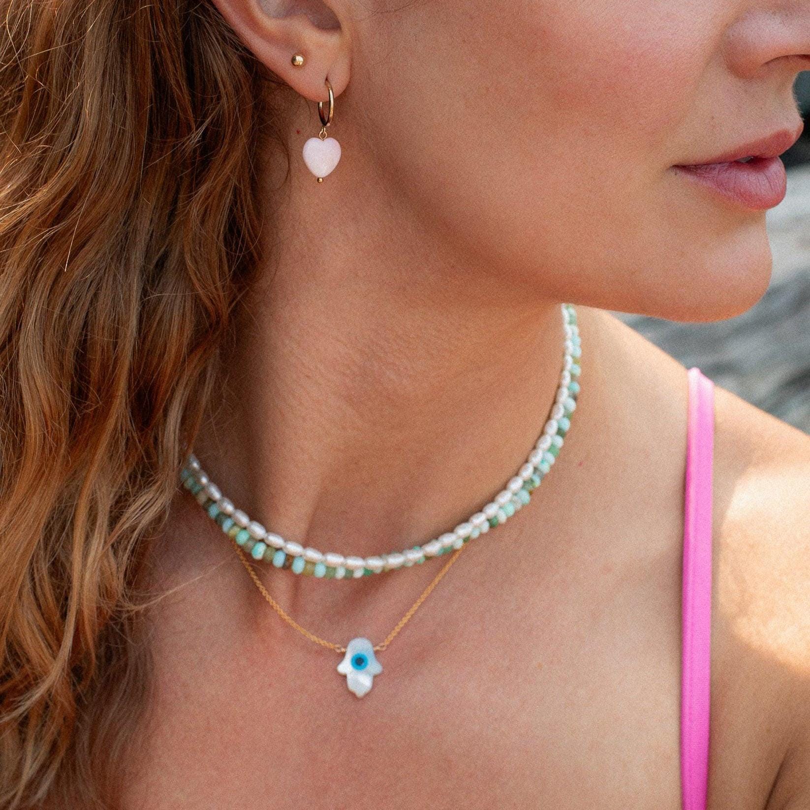 Peruvian opal necklace with colorful gemstone beads from Earthly Abundance displayed on a white background.