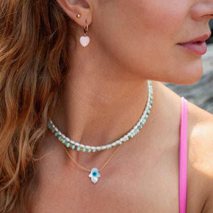 Peruvian opal necklace with colorful gemstone beads from Earthly Abundance displayed on a white background.