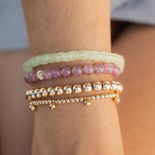 Madagascar Rose Quartz bracelet by Earthly Abundance featuring polished pink quartz beads on an elastic cord.