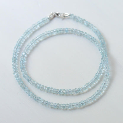 Earthly Abundance aquamarine choker necklace featuring a vibrant blue gemstone pendant on a delicate chain.