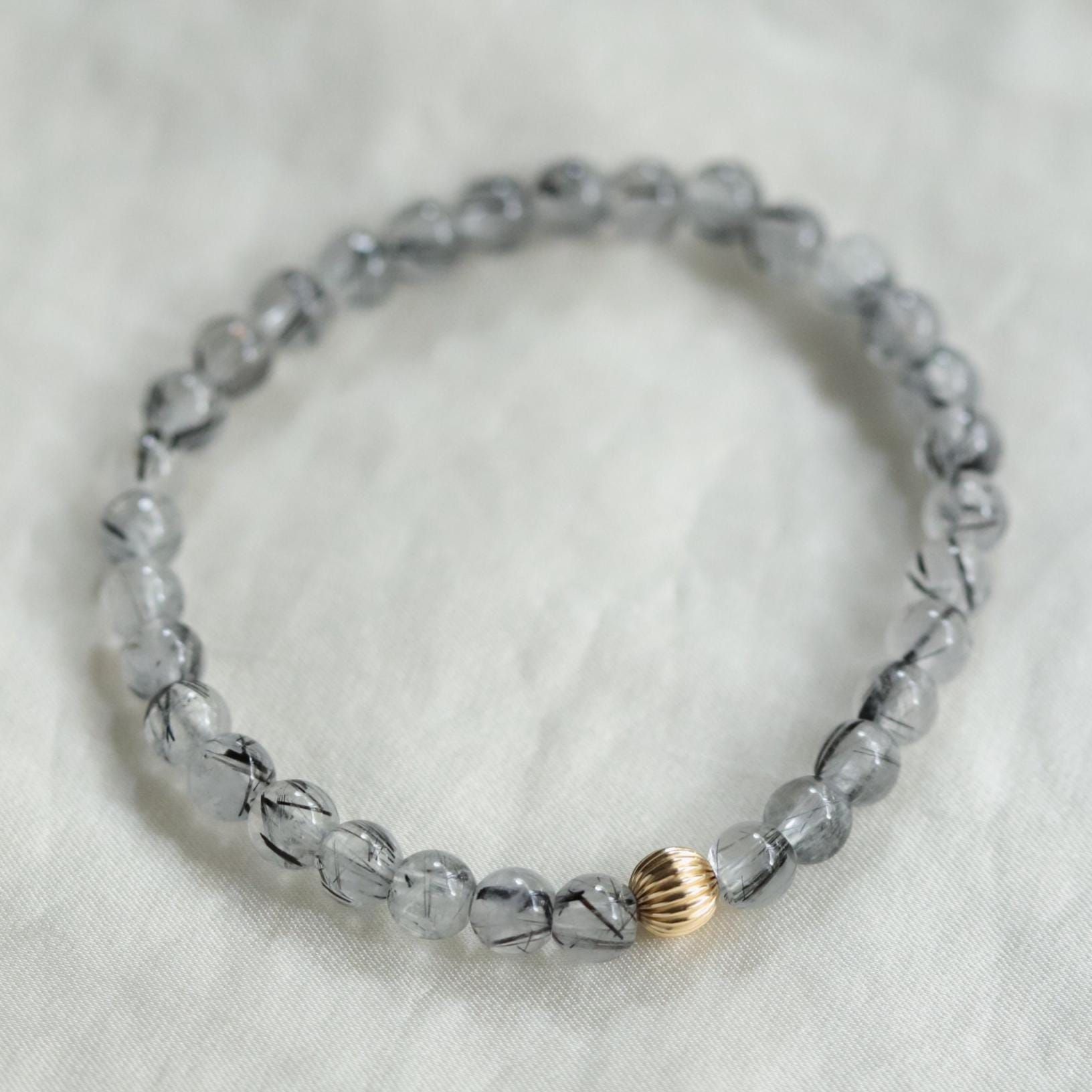 Black rutilated quartz with evil eye charm