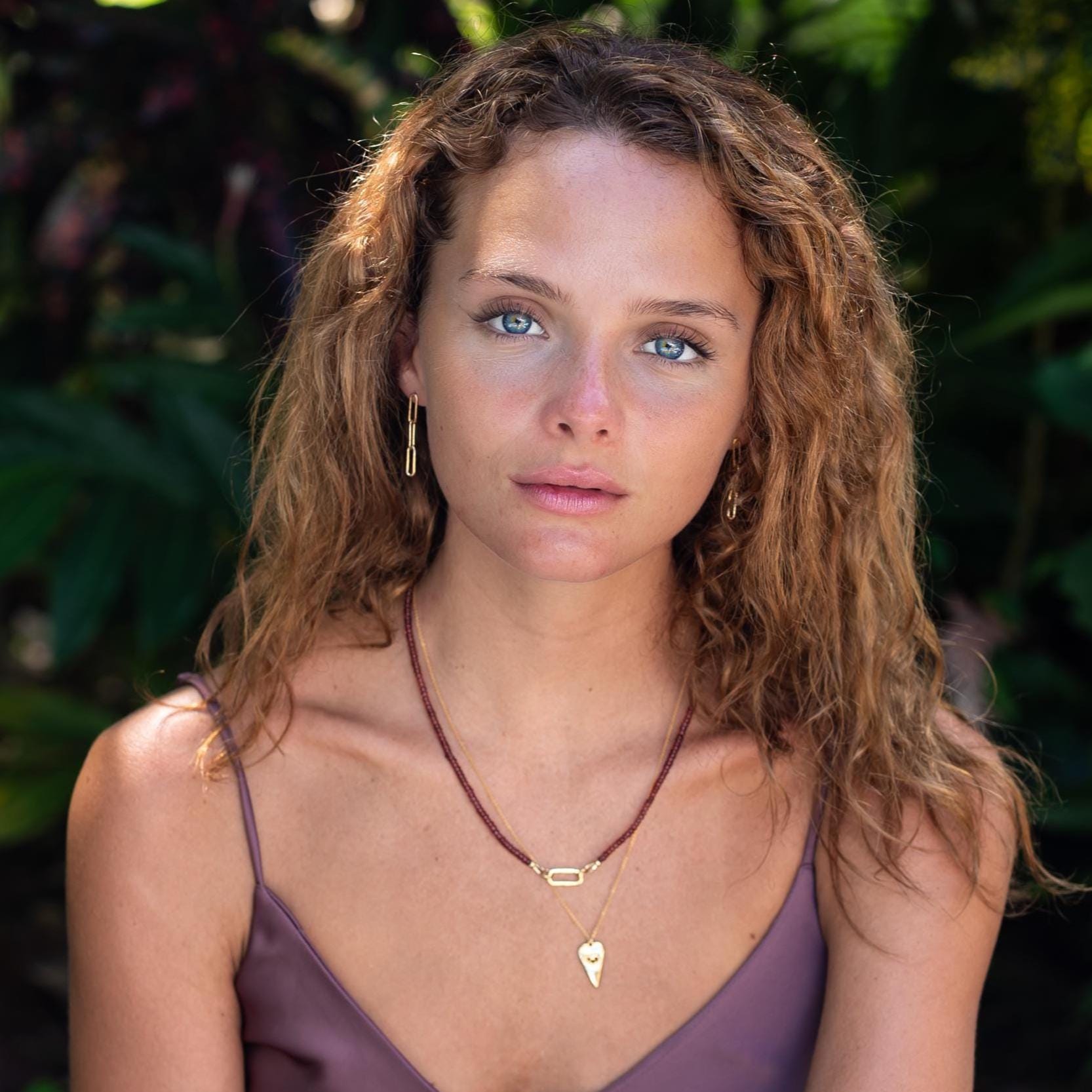 Garnet carabiner necklace by Earthly Abundance featuring a polished garnet stone on a silver chain.