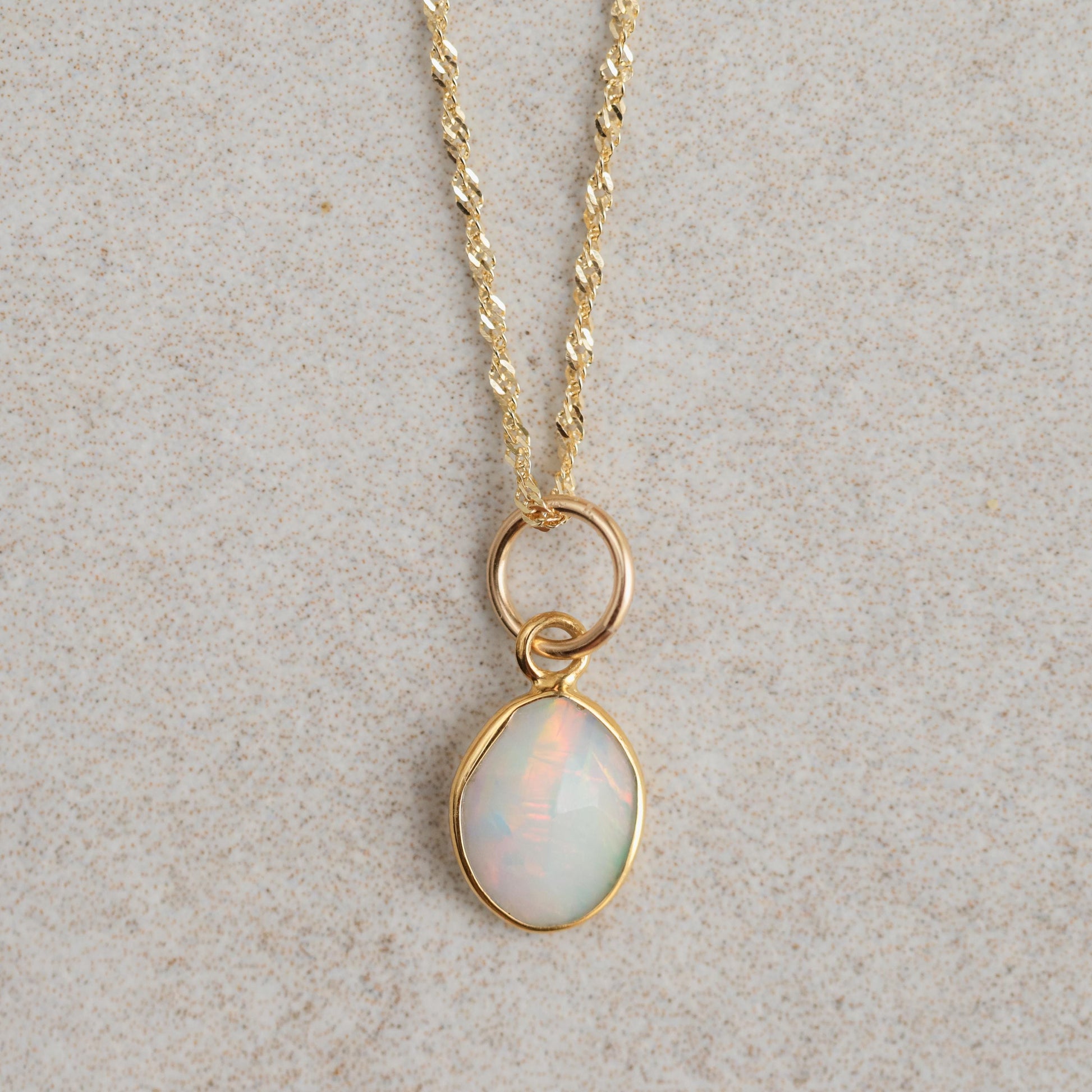 Ethiopian Opal Necklace with 14K gold chain from Earthly Abundance, featuring a vibrant, iridescent opal pendant on a delicate chain.