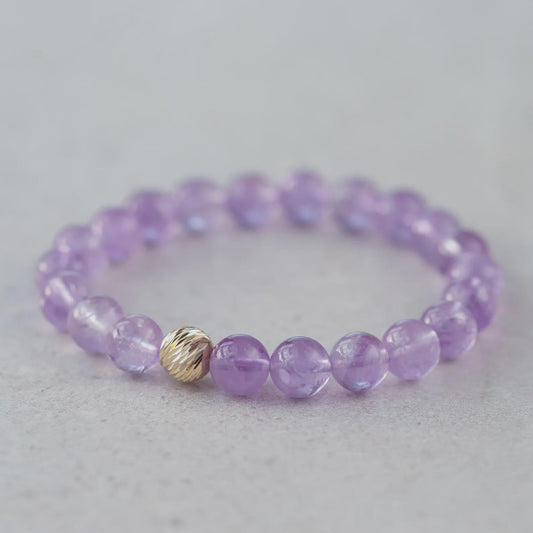 Lavender amethyst bracelet with 14K gold accents from Earthly Abundance, featuring polished lavender amethyst beads and gold clasp.