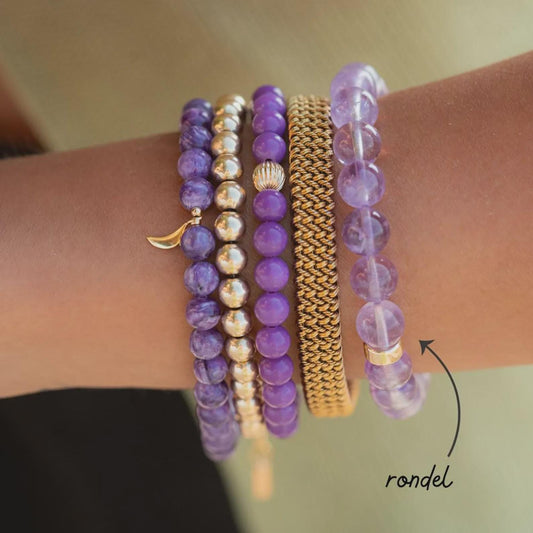Lavender Amethyst bracelet with 14K gold setting from Earthly Abundance, featuring polished purple amethyst stones on a delicate gold chain.