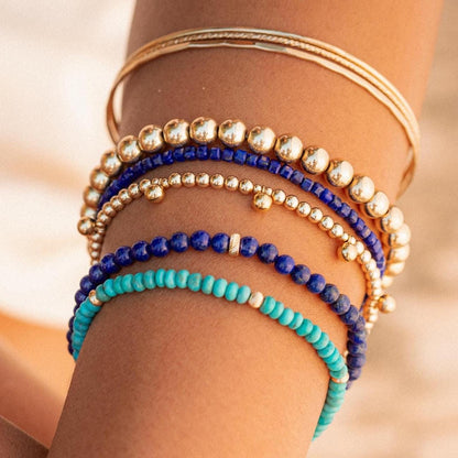 Lapis Lazuli bracelet with 14K gold accents from Earthly Abundance Jewelry, featuring deep blue stones and intricate design.