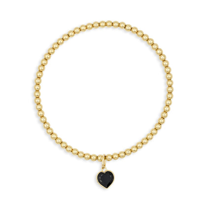 Gold filled black spinel heart bracelet with 14K gold charm, featuring a stylish and elegant jewelry piece from Earthly Abundance.