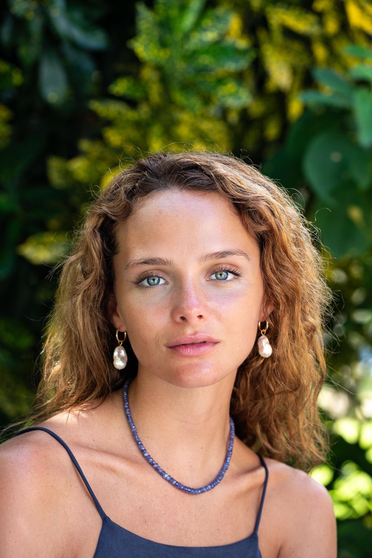 Indigo Muse Tanzanite Necklace by Earthly Abundance Jewelry featuring a stunning tanzanite pendant on a delicate chain.