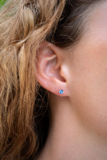 Earthly Abundance Tanzanite stud earrings featuring vibrant blue-purple tanzanite gemstones set in silver or gold.