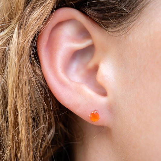 Solid gold carnelian stud earrings from Earthly Abundance featuring round orange gemstones on gold posts.
