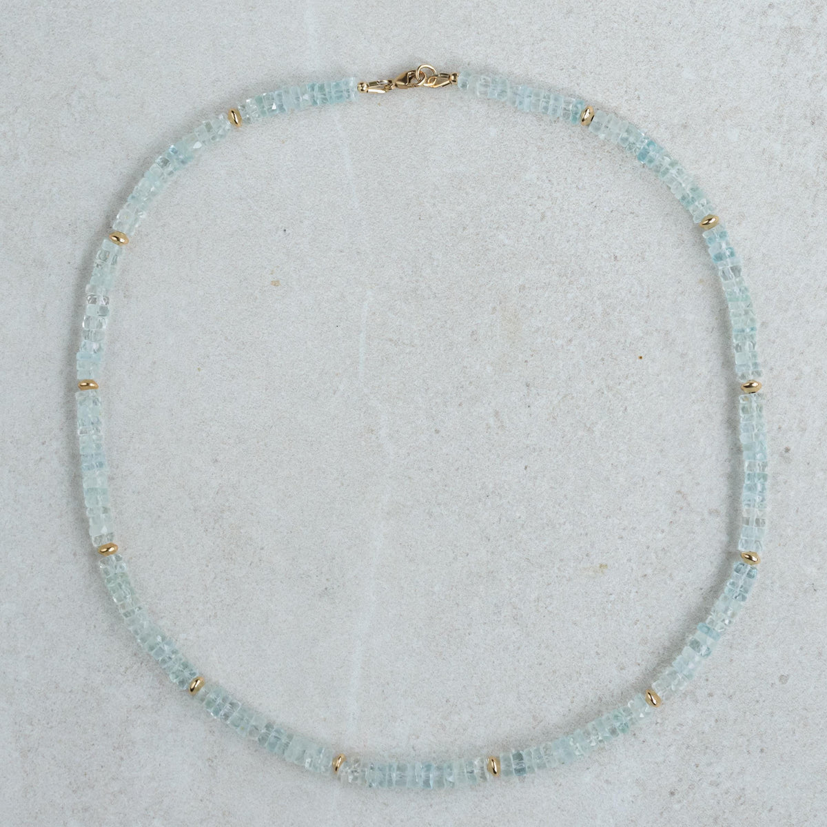 Blue Topaz Heishi necklace with small round beads, featuring a silver clasp, crafted by Earthly Abundance.