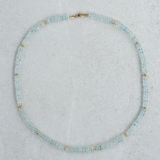 Blue Topaz Heishi necklace with small round beads, featuring a silver clasp, crafted by Earthly Abundance.