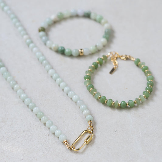 Burmese Jade 6mm beads from Earthly Abundance, showcasing smooth, polished green jade gemstones arranged in a string.