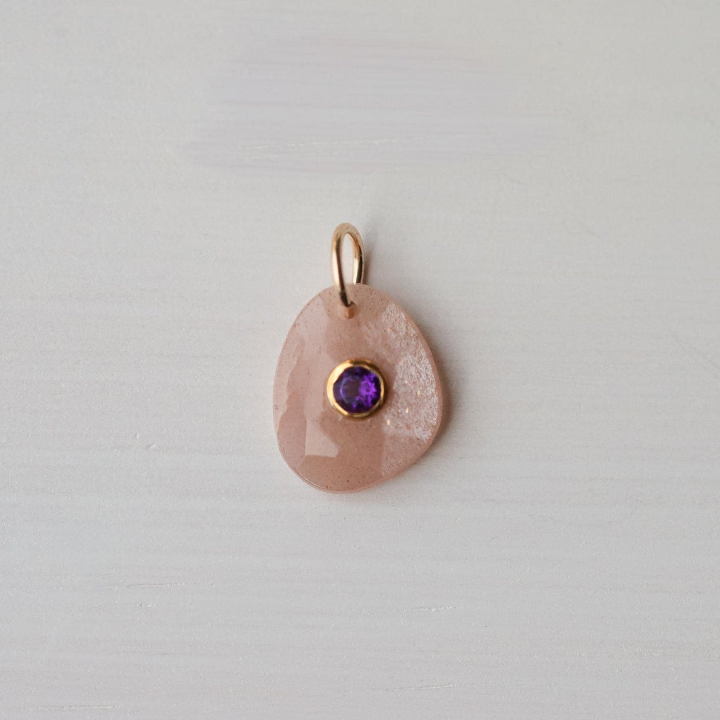 Dawn Muse pendant by Earthly Abundance featuring peach moonstone and amethyst gemstones in a delicate silver setting.