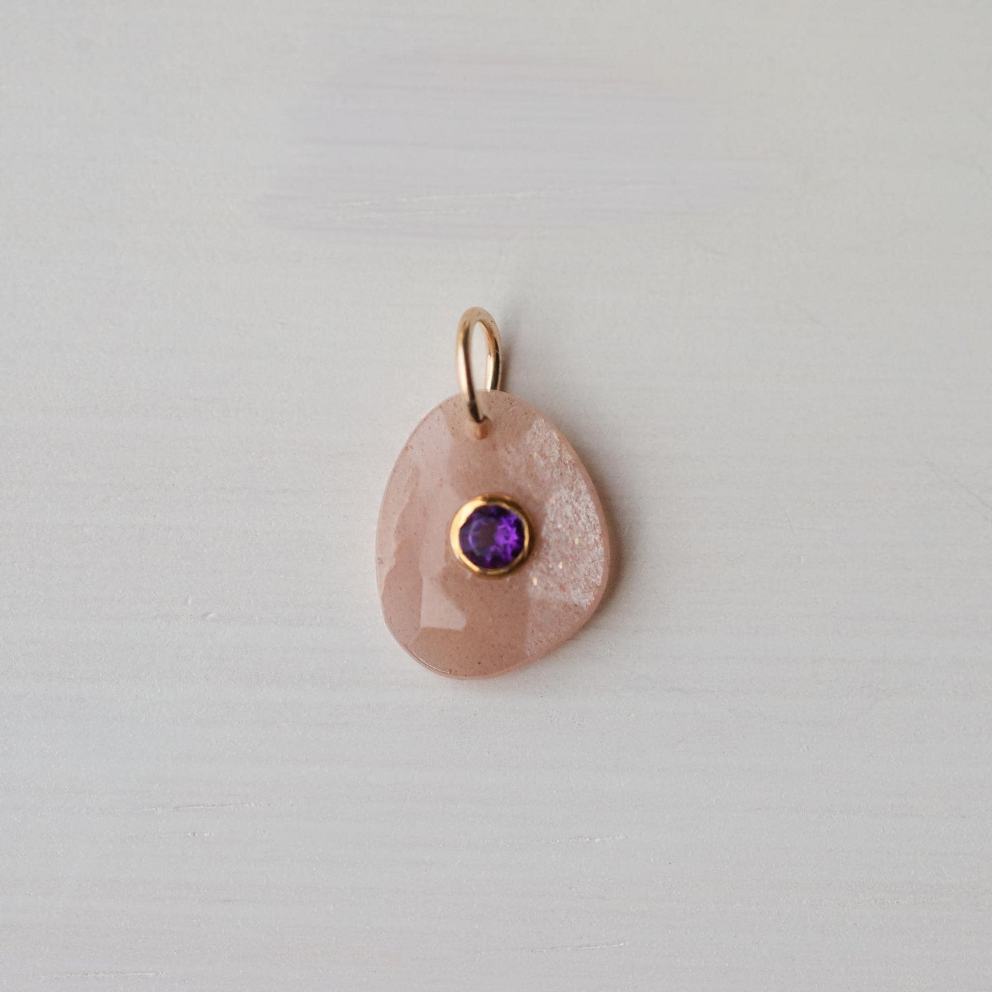 Dawn Muse pendant by Earthly Abundance featuring peach moonstone and amethyst gemstones in a delicate silver setting.