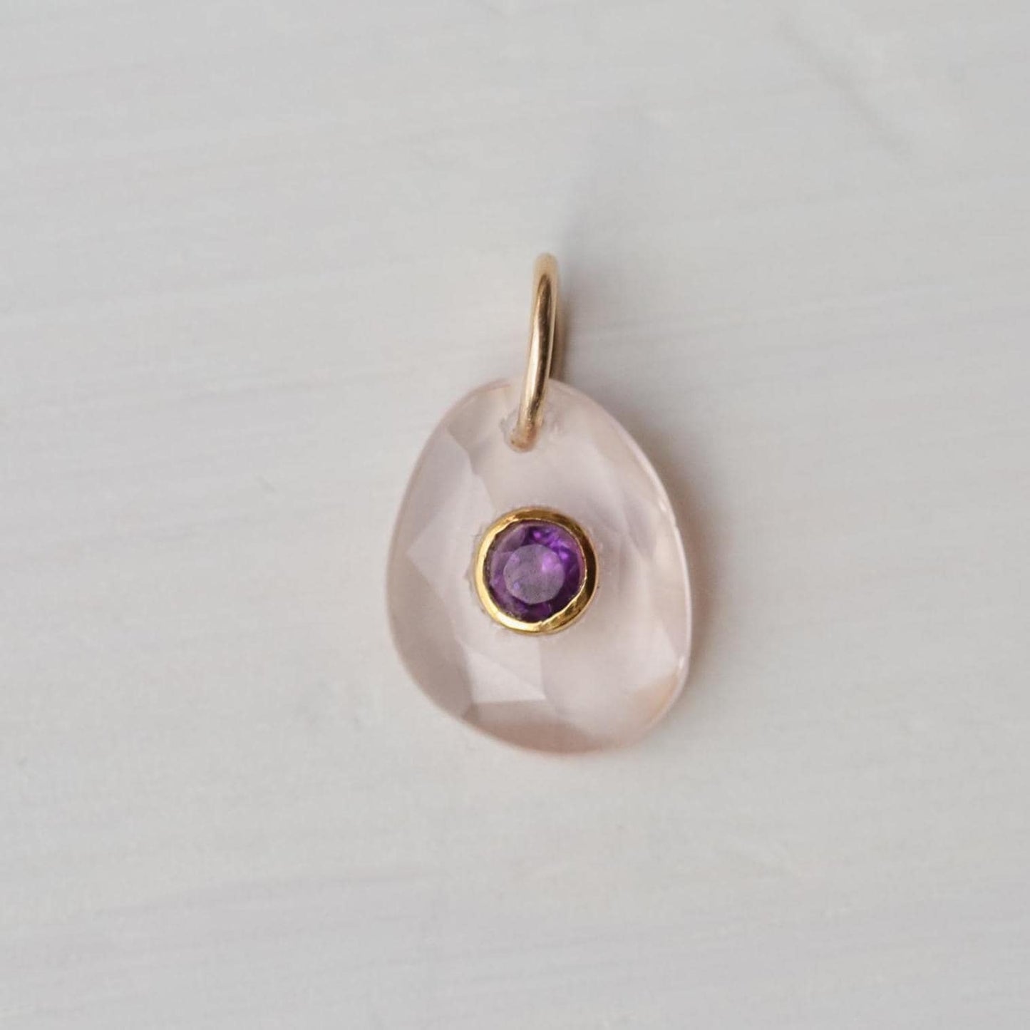 Roselight pendant featuring rose quartz and amethyst gemstones, crafted by Earthly Abundance, showcasing the pendant's elegant design.